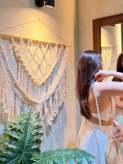 A mirror selfie, showing the back of my crochet top.