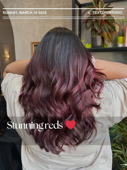 Stunning reds are always a favorite. This look features a deep, vibrant red that's rich and eye-catching, styled into soft, glamorous waves.