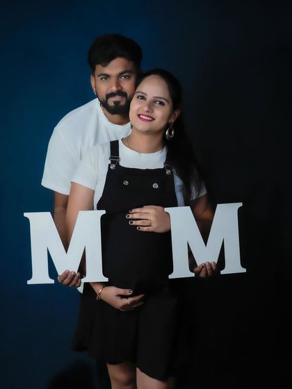 A fun studio portrait for a couple who loves a modern aesthetic. The large "M" and "M" letters add a graphic, personalized element to their announcement.