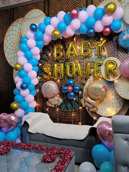 This angle shows how the balloon arch elegantly frames the seating area, making it the perfect spot for the mom-to-be to sit and enjoy her special day.