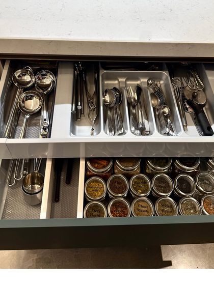 A two-tier drawer with cutlery on top and spices below. This is a perfect example of how we create high-density storage systems that are still easy to navigate.