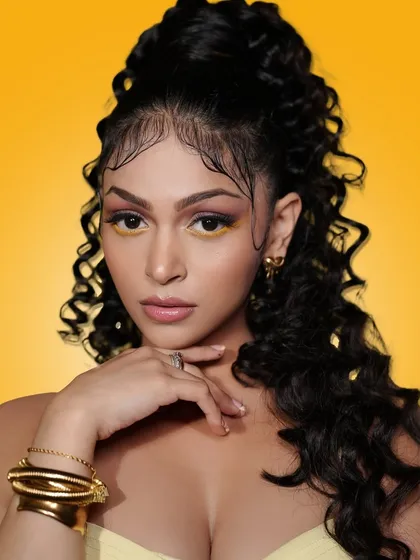 I love experimenting with current trends, like this look from my "Summer Edit" campaign. It features a pop of yellow on the eyes, glowing skin, and a modern curly ponytail, showing my ability to create fun, fashionable, and contemporary makeup styles.