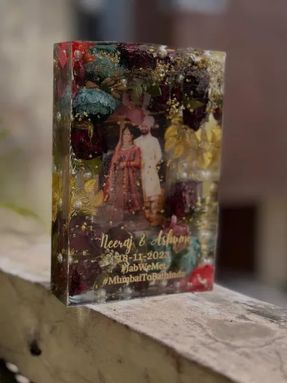 This rectangular resin block stands tall, showcasing a beautiful wedding photo surrounded by a mix of colorful preserved flowers. A perfect statement piece for a side table.