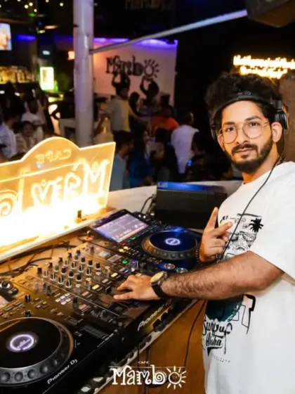 A wide shot of my complete DJ setup at Cafe Mambo. The illuminated logo and complex mixer show the professional-grade equipment I use for every gig.