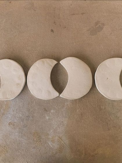 Four moon-phase trinket dishes, hand-built from white clay. These are perfect for holding jewelry or simply as a beautiful, minimalist decoration.