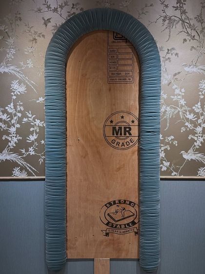 A work-in-progress shot of the pleated mirror frame being prepared against the backdrop of the newly installed wallpaper. This image captures the moment where different handcrafted layers start coming together to form a cohesive whole.