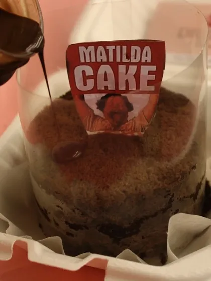 Our take on the famous Matilda Cake. This pull-me-up cake comes with a side of rich chocolate sauce to pour over, creating a wonderfully messy and indulgent experience.