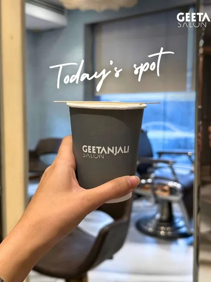 Your spot for a moment of peace and a great cup of coffee. This image captures the relaxing vibe of our Defence Colony salon, where you can unwind during your transformation.