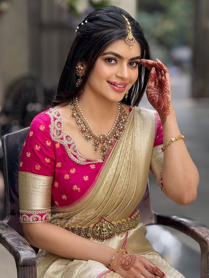 A smiling portrait of the bride, showcasing her beautiful smile and the natural, glowing makeup that enhances her features.
