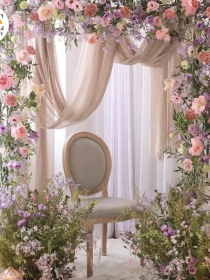 A lush and romantic floral arch in shades of pink and lavender, creating a perfect photo backdrop or a beautiful frame for a ceremony.