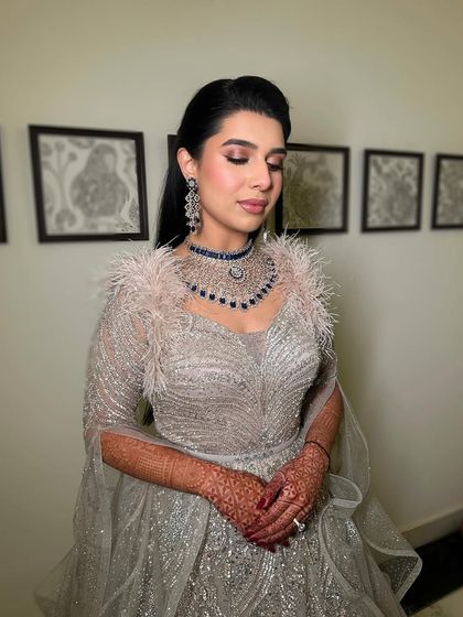 A close-up of the sparkling eyes and blushed cheeks, which are the centerpiece of this glamorous reception look.