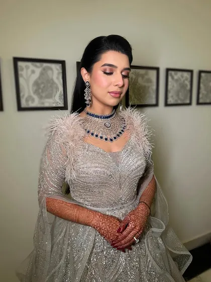 A close-up of the sparkling eyes and blushed cheeks, which are the centerpiece of this glamorous reception look.