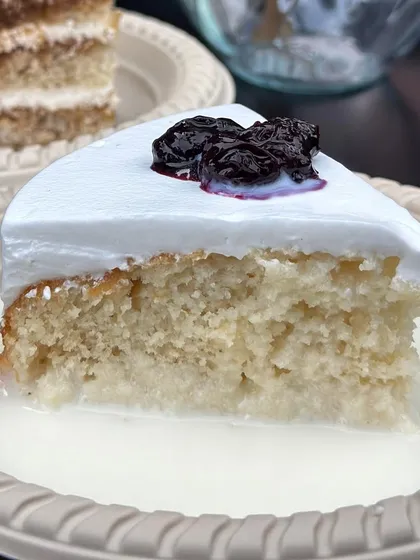 Discover our signature Milk Pastry, a dessert that’s all about texture. It’s an incredibly soft, eggless vanilla sponge soaked in a sweet milk syrup, finished with a dollop of our house-made berry compote.