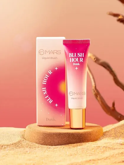 A desert-themed shot for the "Blush Hour Dusk" liquid blush. We used sand and driftwood to create a warm, earthy landscape, with a soft, pink-toned background to mimic the colors of a sunset.
