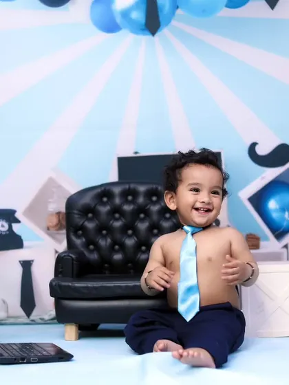 A happy 'Boss Baby' enjoying his office setup. The tie and big smile make this shot priceless.