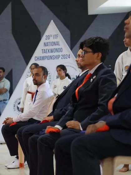 A candid shot from the officials' seating area. These long days are fueled by a deep passion for the sport and a commitment to its participants.