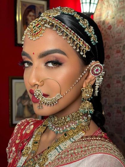 A detailed shot of the South Indian bridal look, focusing on the intricate nath and the bold eye makeup. This is a look for a bride who wants to make a statement.