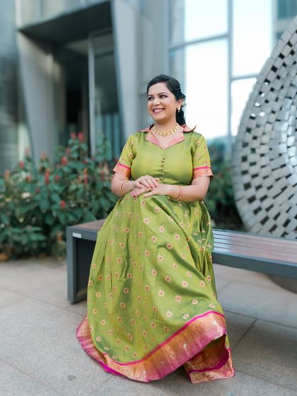A beautiful portrait of a guest or family member in a unique green traditional dress.