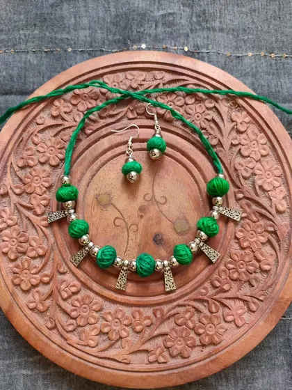 This thread bead necklace is available in a variety of colors like orange, green, yellow, blue, and red. It's a simple yet elegant accessory, perfect for adding a pop of color to your festive wear.