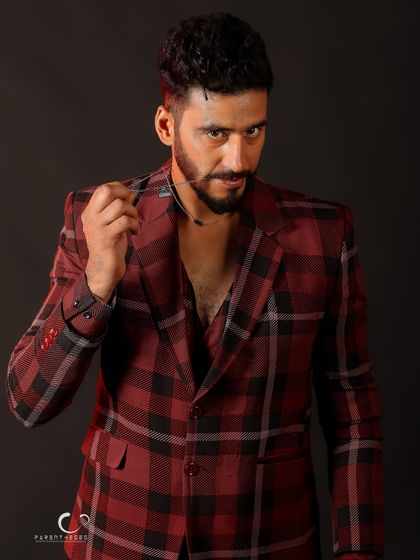 An intense and engaging portrait. The prop and pose create a sense of narrative and character, making the image more than just a headshot.