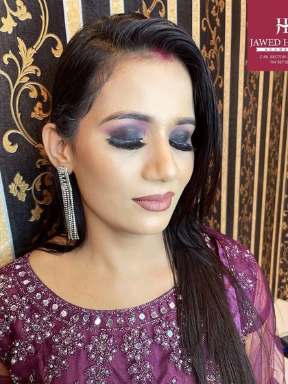 A demonstration of a classic smokey eye with a hint of purple, paired with a nude lip for a balanced, glamorous look.