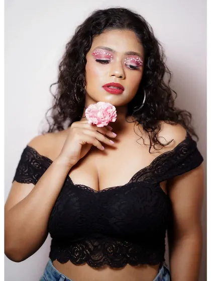 This image shows the pearl-embellished eye makeup from a different angle, paired with a black lace top. The look is both soft and artistic, suitable for creative portraits.