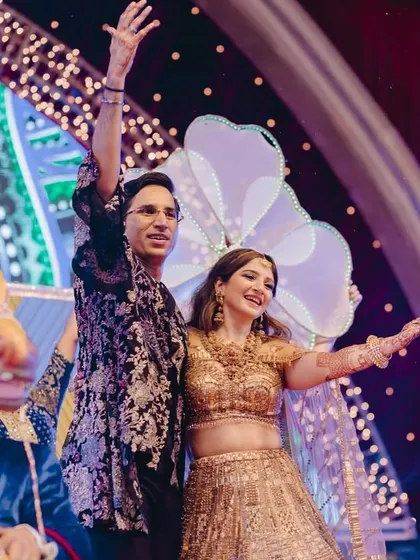A grand entry onto the Sangeet stage, ready to kick off a night of performances and celebration.
