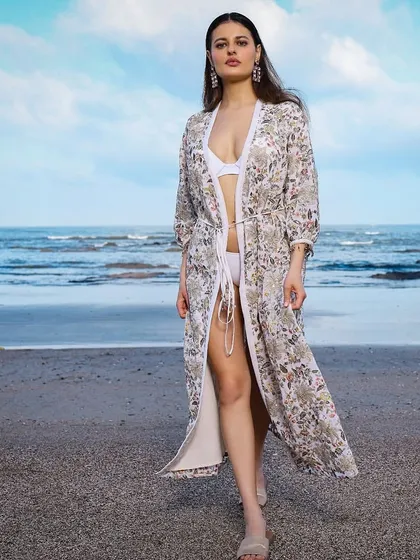 This look was for a resort wear brand's online store shoot. I paired a light, floral embroidered cover-up with a simple white bikini to create an effortlessly chic beach aesthetic that feels both bold and serene.
