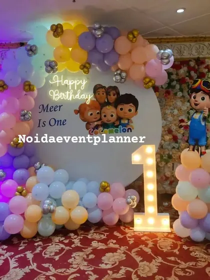 We bring popular cartoons to life, like this Cocomelon first birthday party featuring a character backdrop, a light-up number '1', and colorful pastel balloons.