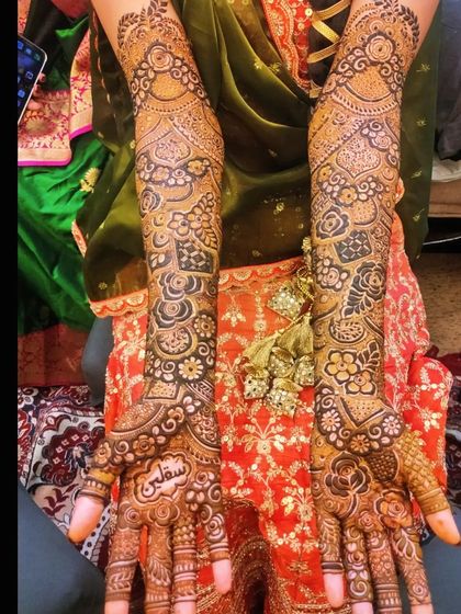 The stunning bridal mehndi for Saqlain's bride, complete with her full bridal attire and jewelry. The rich stain looks incredible.