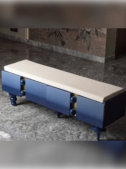 This ombre blue bench is designed as a conversational piece. The unique, hand-turned legs are all different, adding a playful and artistic element to the functional seating. It is a piece that invites a closer look.