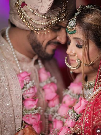 A romantic close-up of the couple. This image shows the detail of her eye makeup and the way it complements the groom's attire.