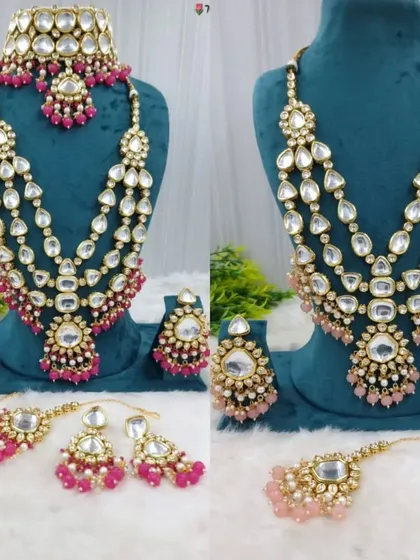 This layered bridal necklace set is available in both rani pink and pastel pink. It's a complete rental set that includes a choker, long necklace, earrings, and maang tikka.