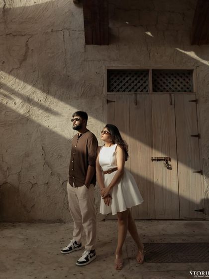 A dramatic portrait of Yash and Kinjal in Dubai, using strong sunlight and shadows to create a visually striking image.