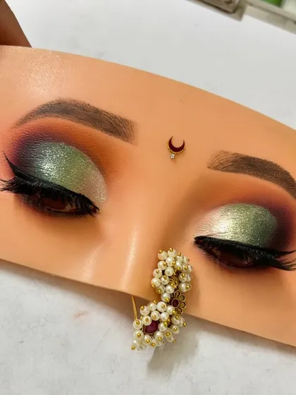 A stunning green and gold half cut crease eyeshadow look. This is a great example of how to play with bold colors for a festive or wedding occasion.