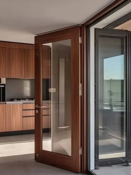 A beautiful wooden and glass bifold door, perfect for connecting an indoor kitchen to an outdoor patio or balcony.