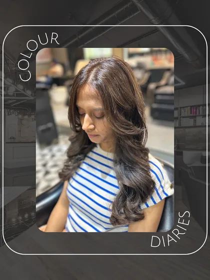 This image captures the soft, elegant feel of a fresh hair color and style. The lighting highlights the glossy finish of her new brown hair.