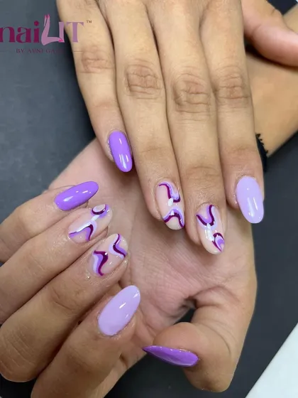 A different angle of the purple abstract design, highlighting the clean lines and the combination of solid and negative space nails.