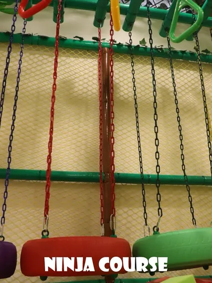 The ninja course features a series of hanging obstacles like these tire swings and rings. It's designed to be a fun physical challenge for active kids.
