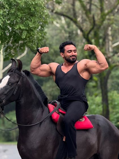 Double bicep pose on horseback.