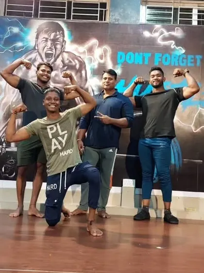 Posing with the team in front of our gym's mural. "Don't Forget To Hustle" is a motto we live by.