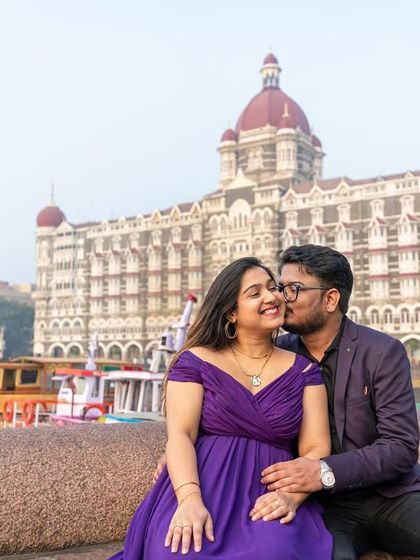 A sweet kiss in front of a Mumbai landmark. The off-shoulder purple gown with its long trail makes for a truly memorable and romantic pre-wedding picture.