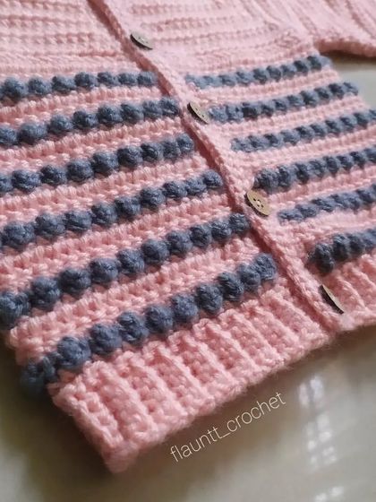 A close-up of the bobble stitch texture on the Dewdrops Cardigan. This detail adds a wonderful tactile element and extra warmth to the sweater.