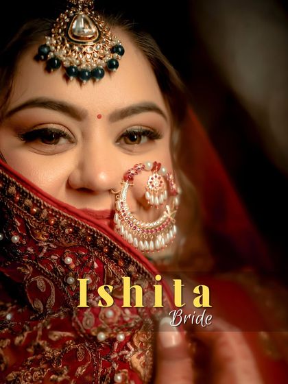 A stunning close-up of the bride, Ishita, her face partially veiled, drawing attention to her expressive eyes and beautiful bridal nath.