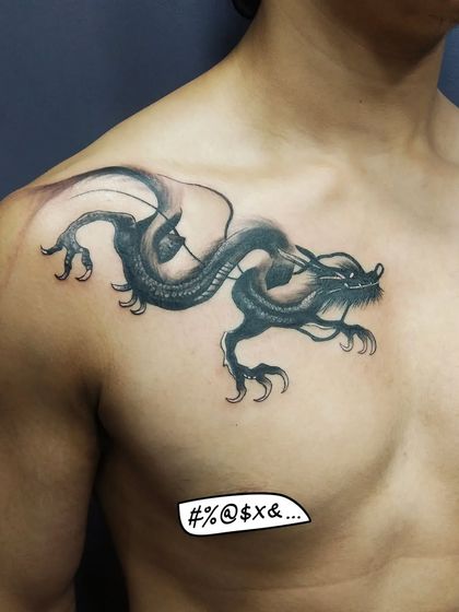 A Japanese-style dragon on the chest and shoulder. The placement is designed to follow the muscles, giving the dragon a sense of movement and power.
