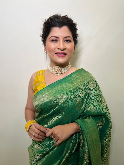 A close-up of Savaniee's flawless makeup. The look features defined brows, soft eye makeup, and a beautiful lip color that completes the ensemble.