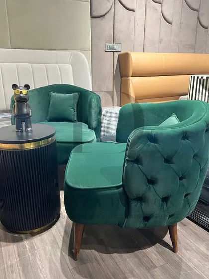 A showcase of my versatile accent chair designs. This includes a green velvet chair with a tufted back, and another model combining floral-print fabric with a mustard-yellow tufted back.