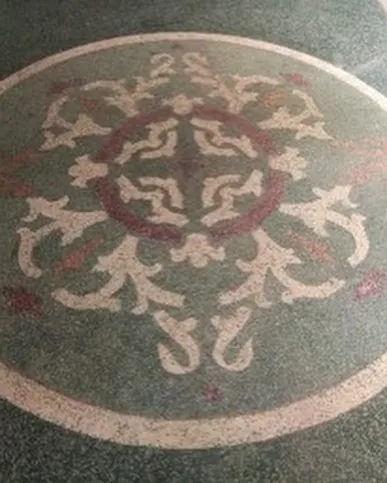 A beautiful circular mosaic pattern found in the flooring, a testament to the high level of craftsmanship in the original construction.