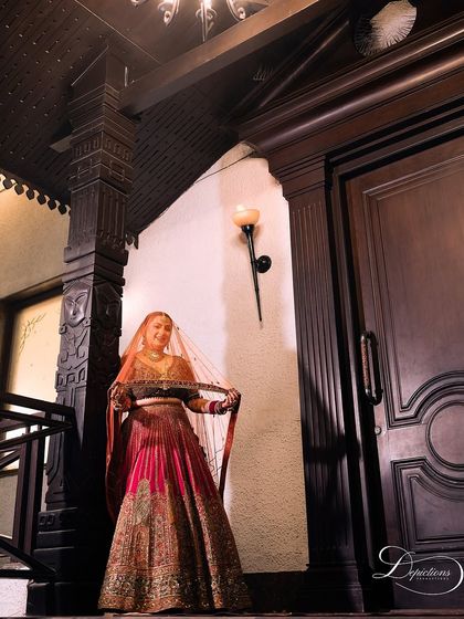 A full-length shot capturing the grandeur of the bridal lehenga and the makeup that completes the look.