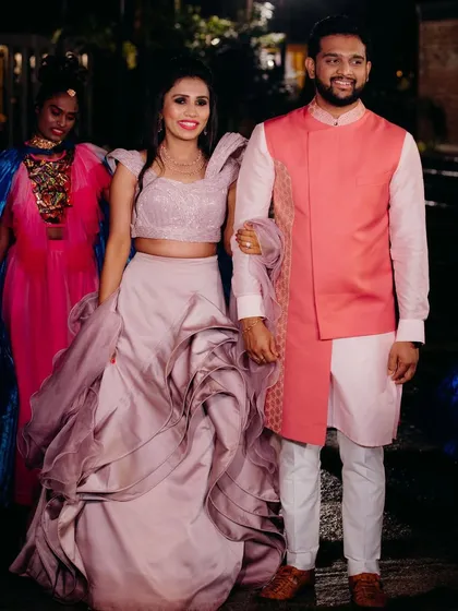 I love creating looks for every function. For this sangeet ceremony, I designed a contemporary layered outfit featuring a stylish pink jacket over a light kurta, perfectly coordinated with his partner's sculpted lehenga for a vibrant, modern couple's statement.